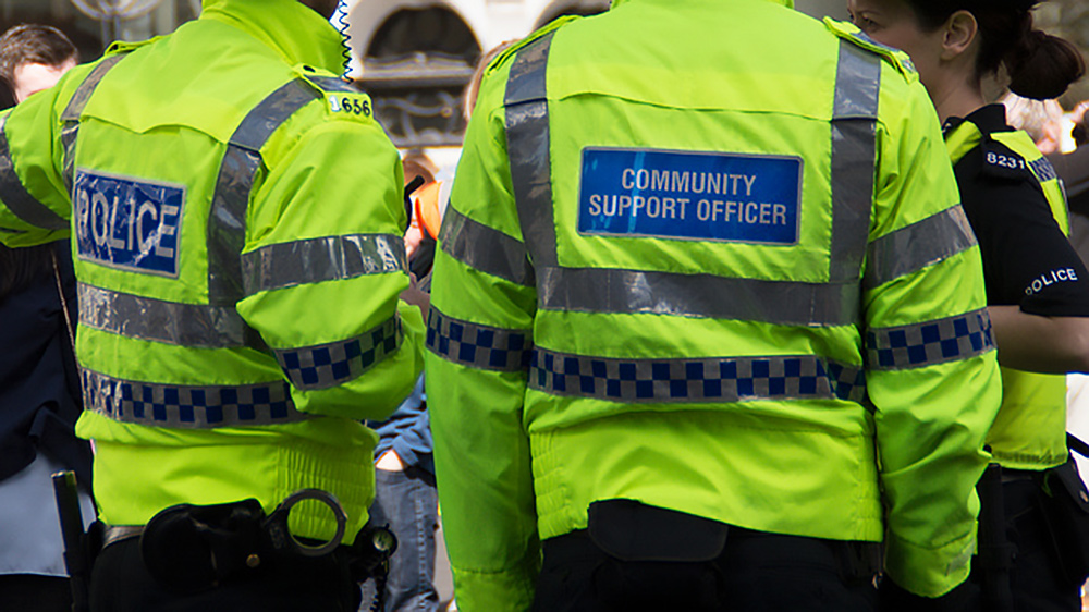 Photograph of police officers and PCSOs in high vis jackets
