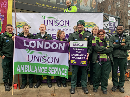 Group of pickets at Waterloo ambulance station, with placards and banners